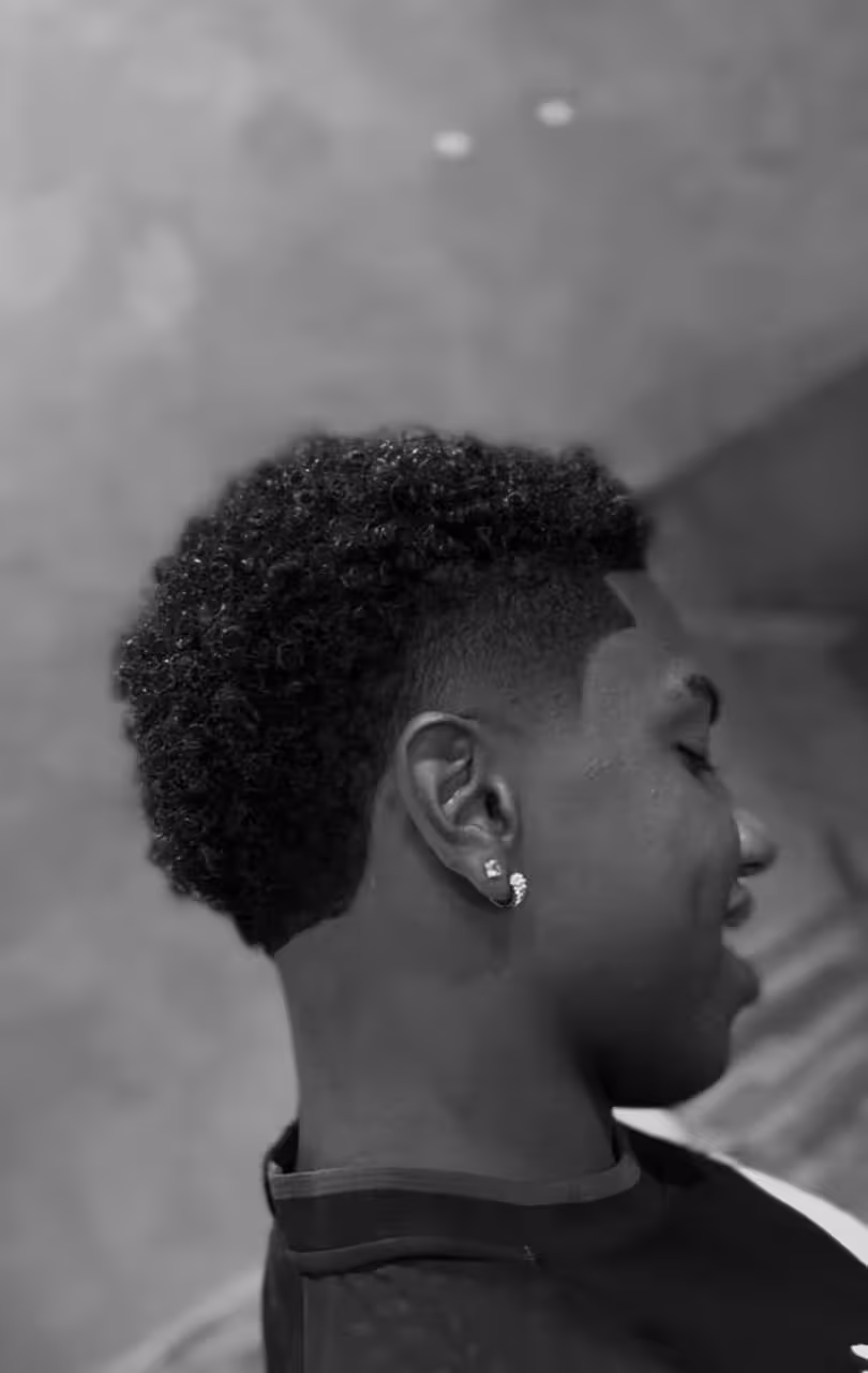 Corte alto em cabelo crespo com degradê e contorno reto na testa